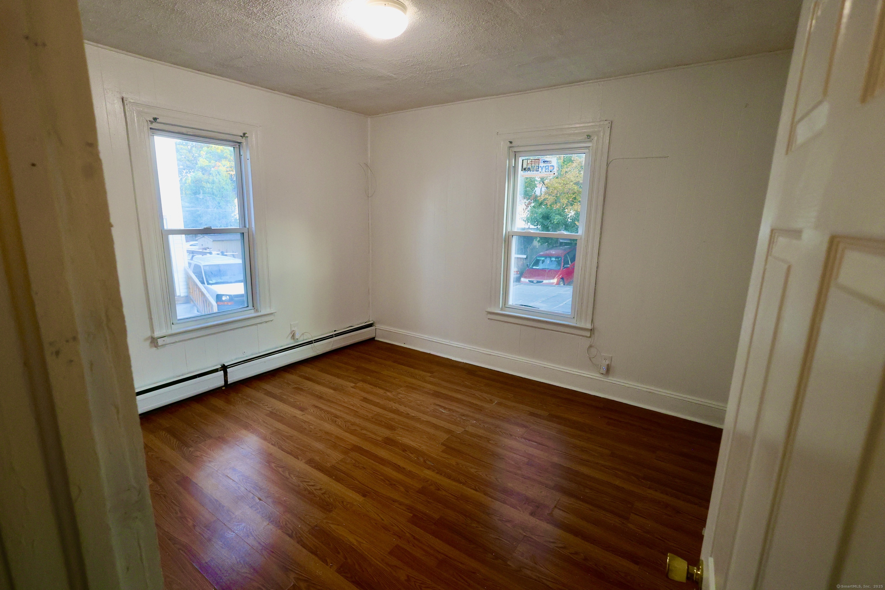 660 West Main Street New Britain, CT 06053 - Photo 14 of 26 an empty room with wooden floor and windows