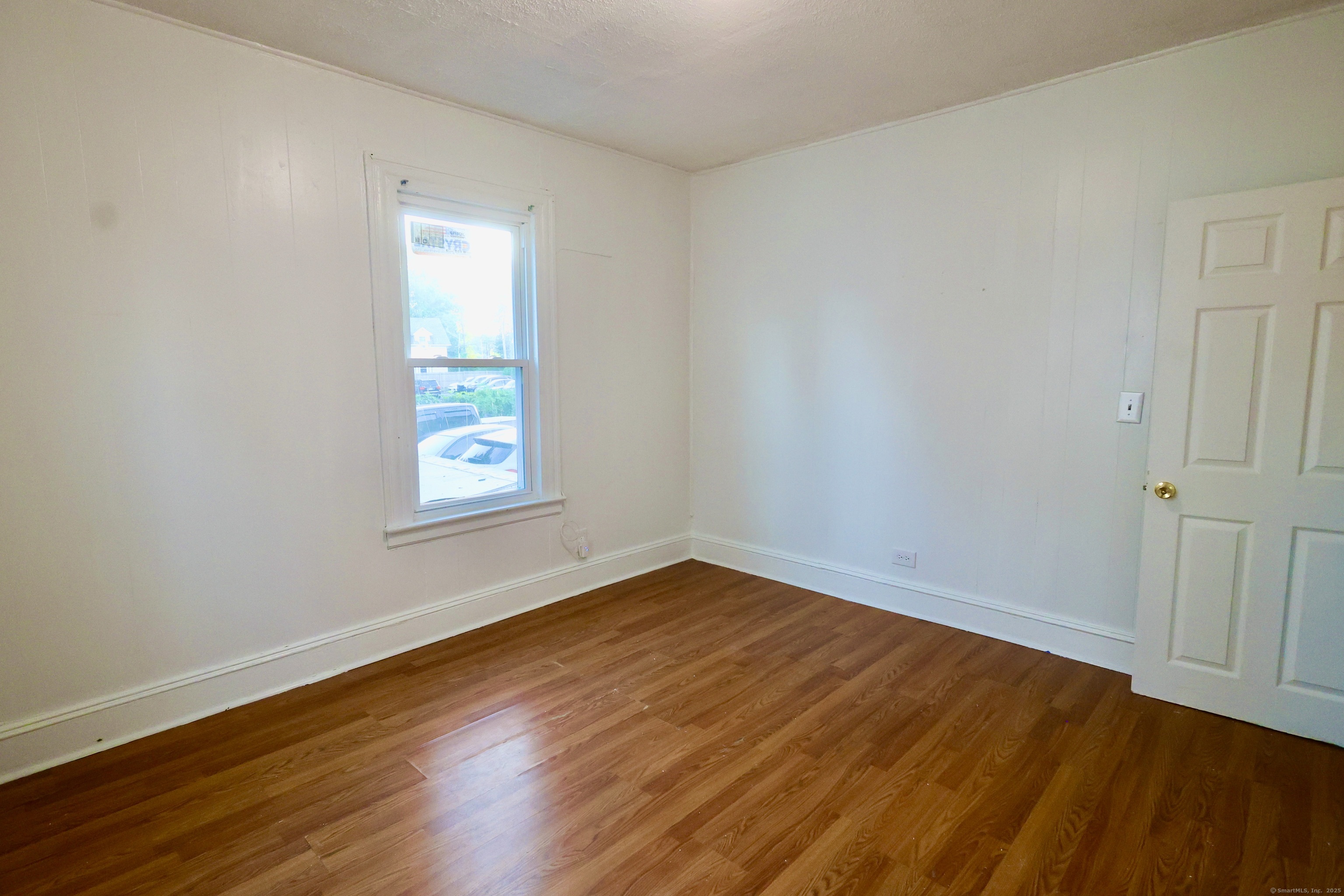 660 West Main Street New Britain, CT 06053 - Photo 16 of 26 an empty room with wooden floor and windows