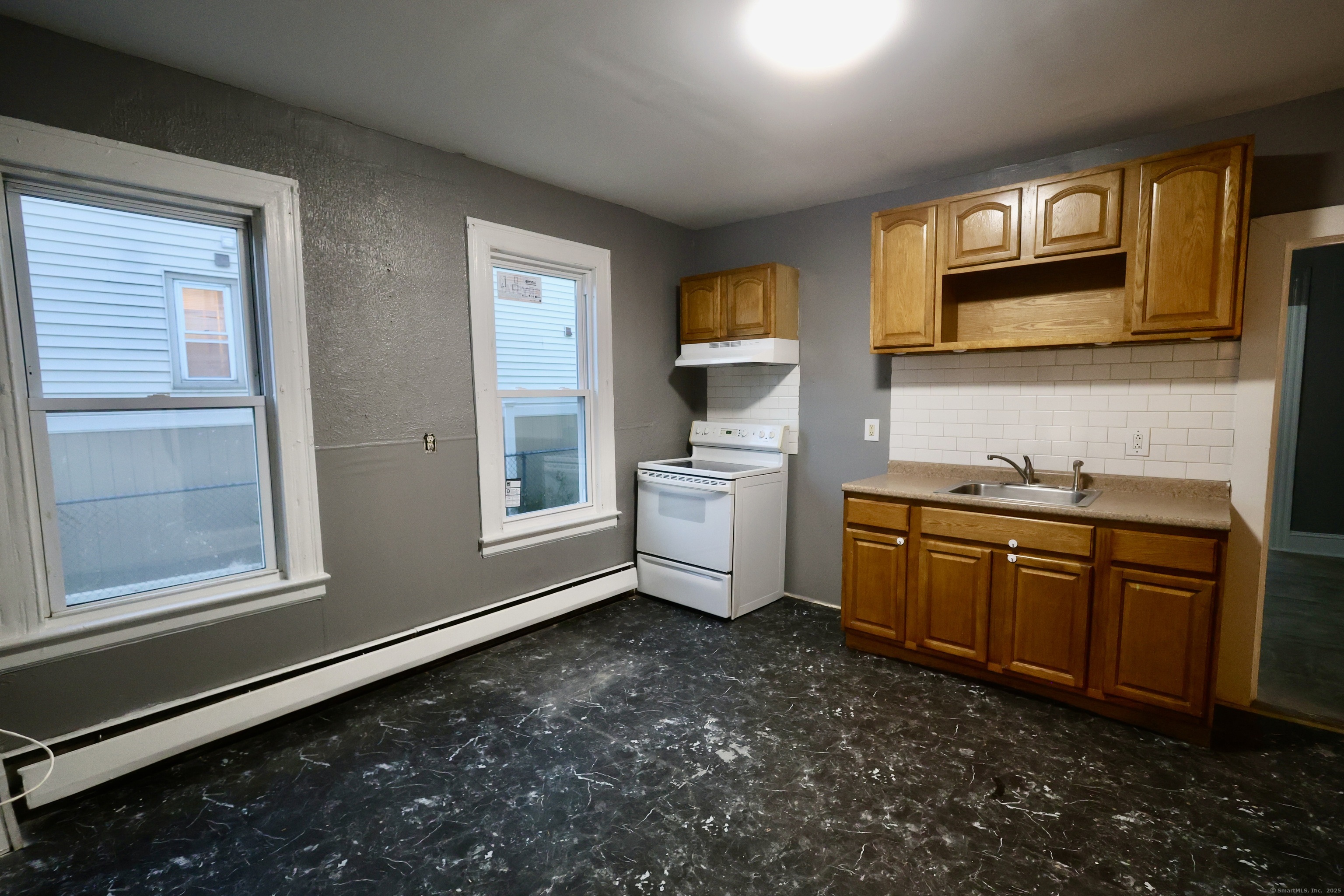 660 West Main Street New Britain, CT 06053 - Photo 2 of 26 a kitchen with sink cabinets and window
