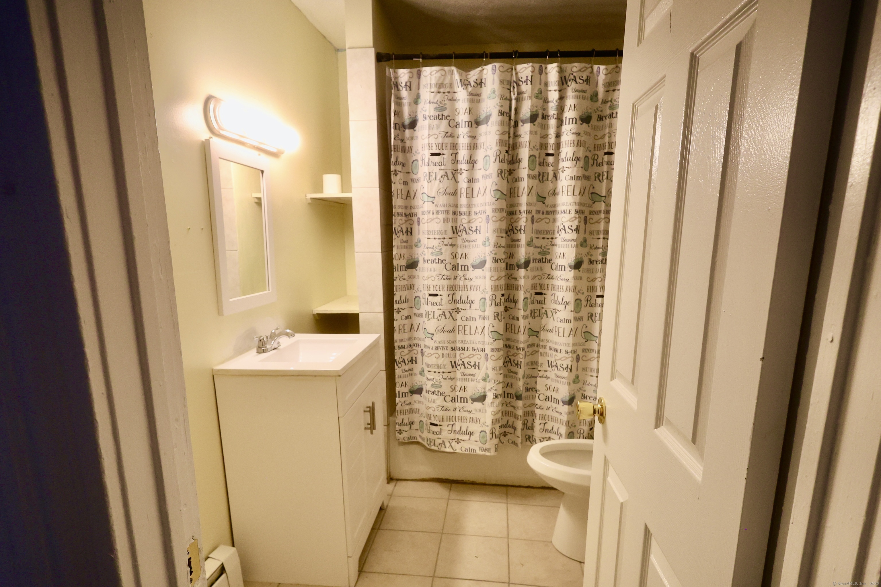 660 West Main Street New Britain, CT 06053 - Photo 22 of 26 a bathroom with a shower curtain and a sink