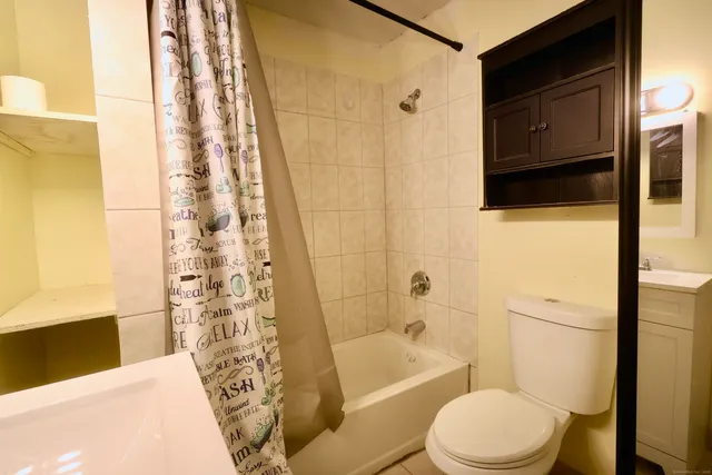 a bathroom with a toilet and shower