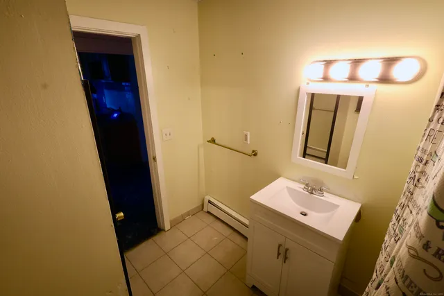 a bathroom with a sink a mirror and vanity