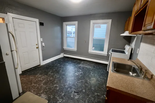 a view of a room with wooden floor and window