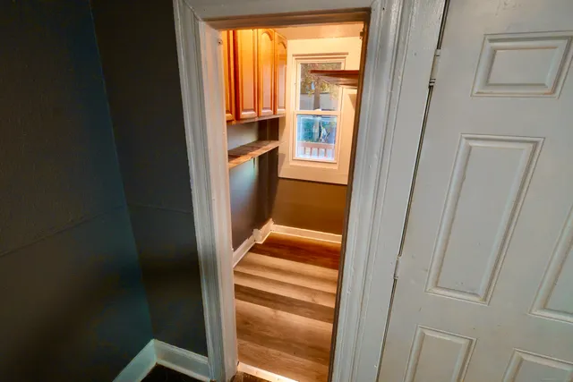 a view of front door with wooden floor