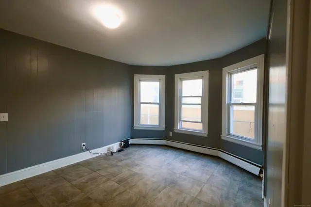 an empty room with a empty space and windows