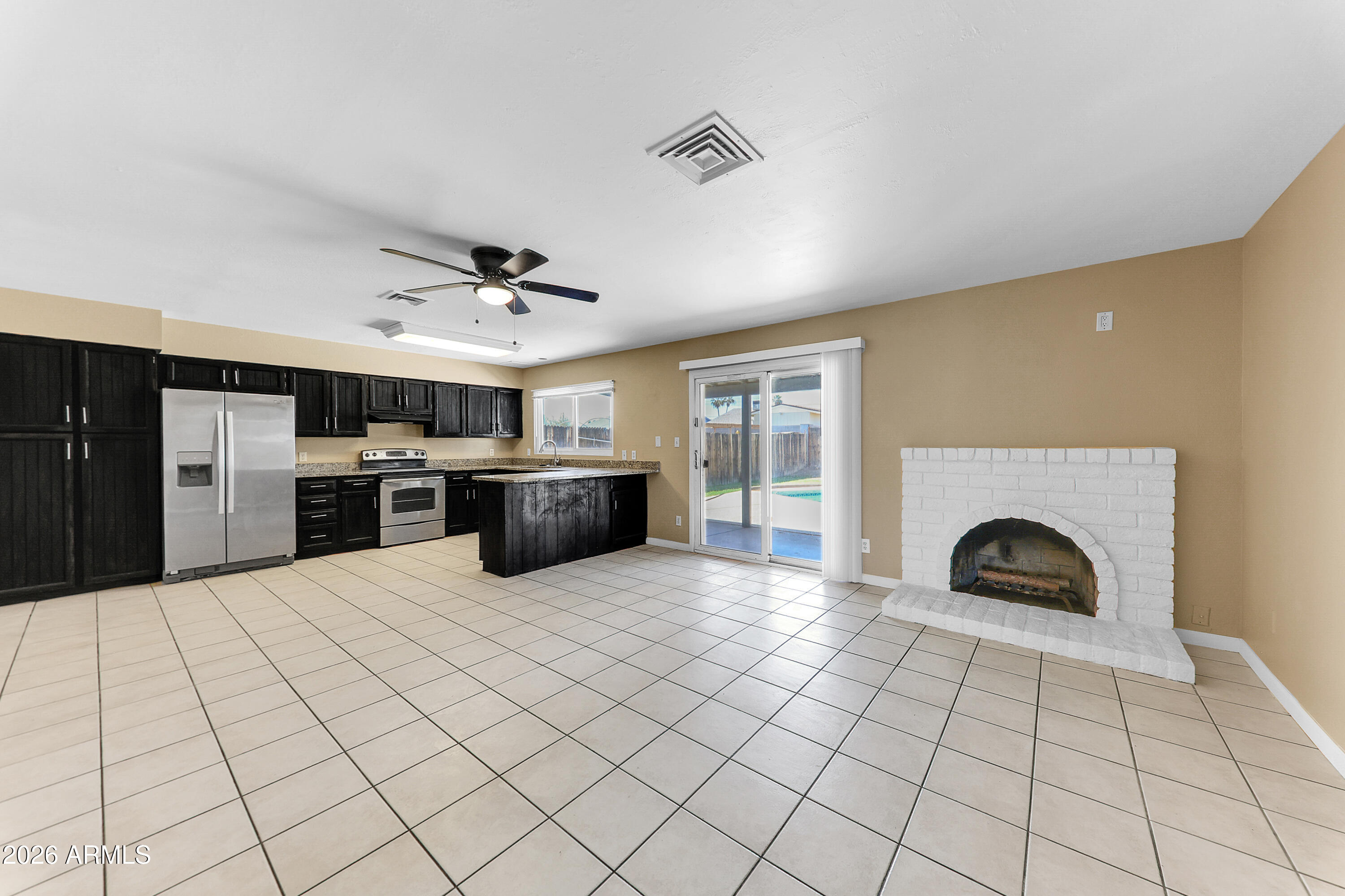 4723 East Vineyard Road Phoenix, AZ 85042 - Photo 7 of 27 a view of a kitchen with furniture and a fireplace