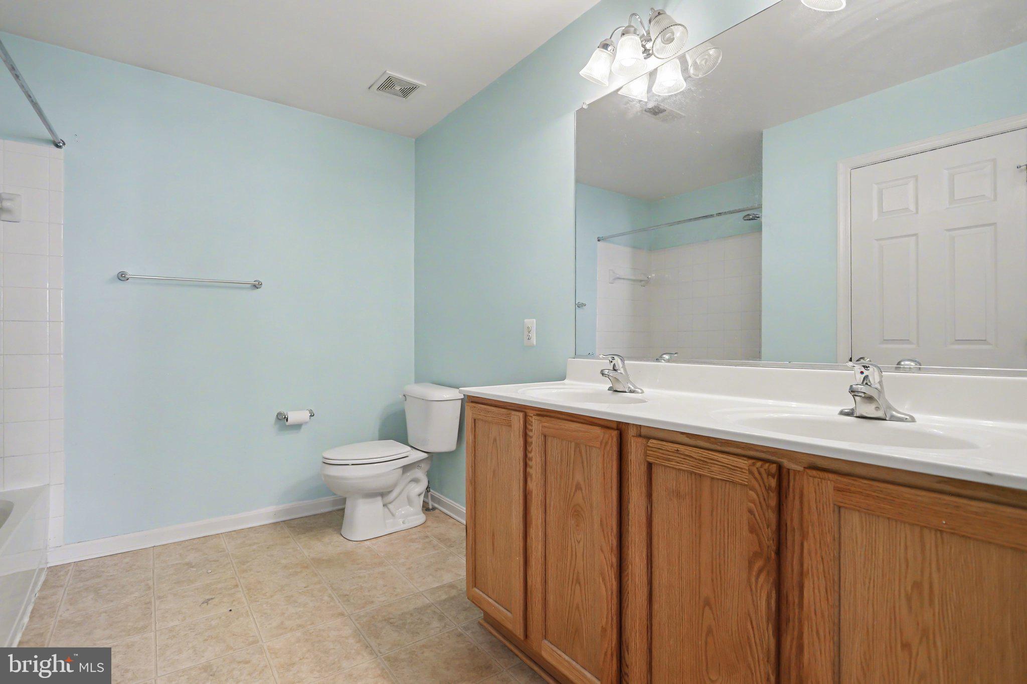 503 Windy Way New Cumberland, PA 17070 - Photo 15 of 29 a bathroom with a double vanity sink toilet and a mirror