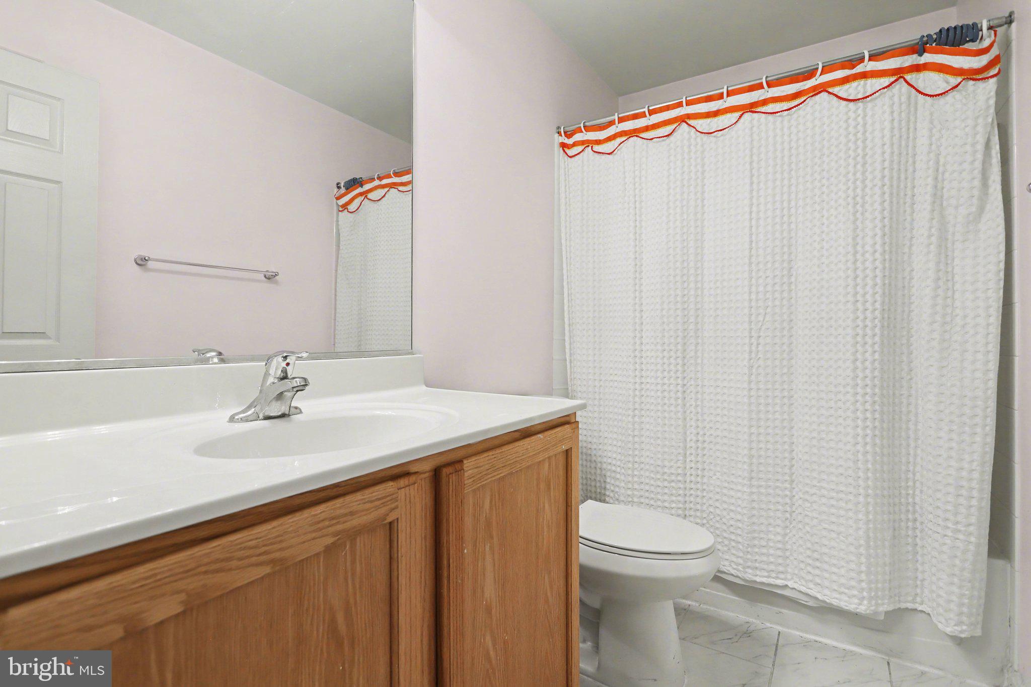 503 Windy Way New Cumberland, PA 17070 - Photo 18 of 29 a bathroom with a sink a toilet and shower curtain