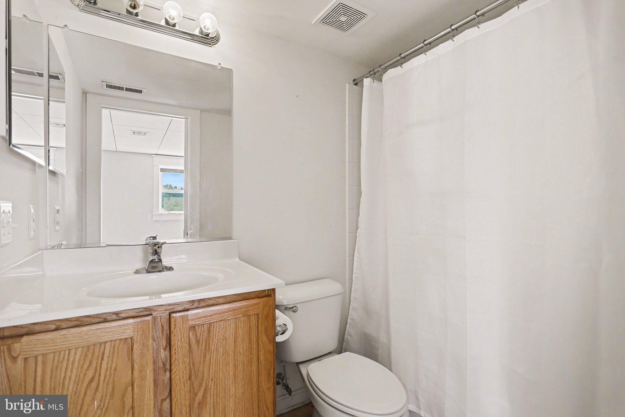 503 Windy Way New Cumberland, PA 17070 - Photo 20 of 29 a bathroom with a sink a toilet and a mirror