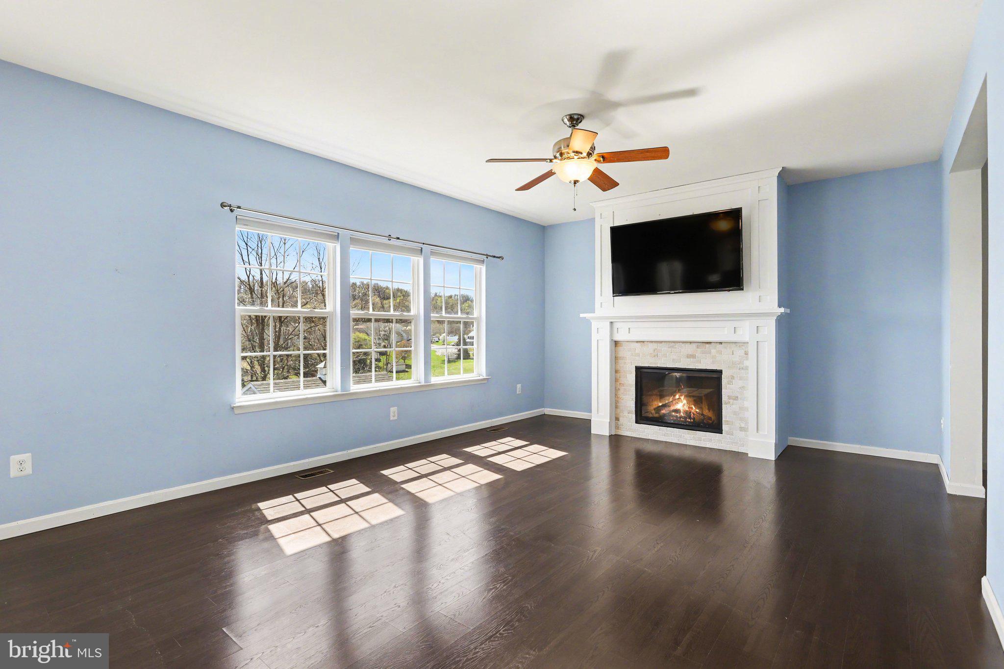 503 Windy Way New Cumberland, PA 17070 - Photo 2 of 29 a view of a livingroom with a fireplace a ceiling fan and wooden floor