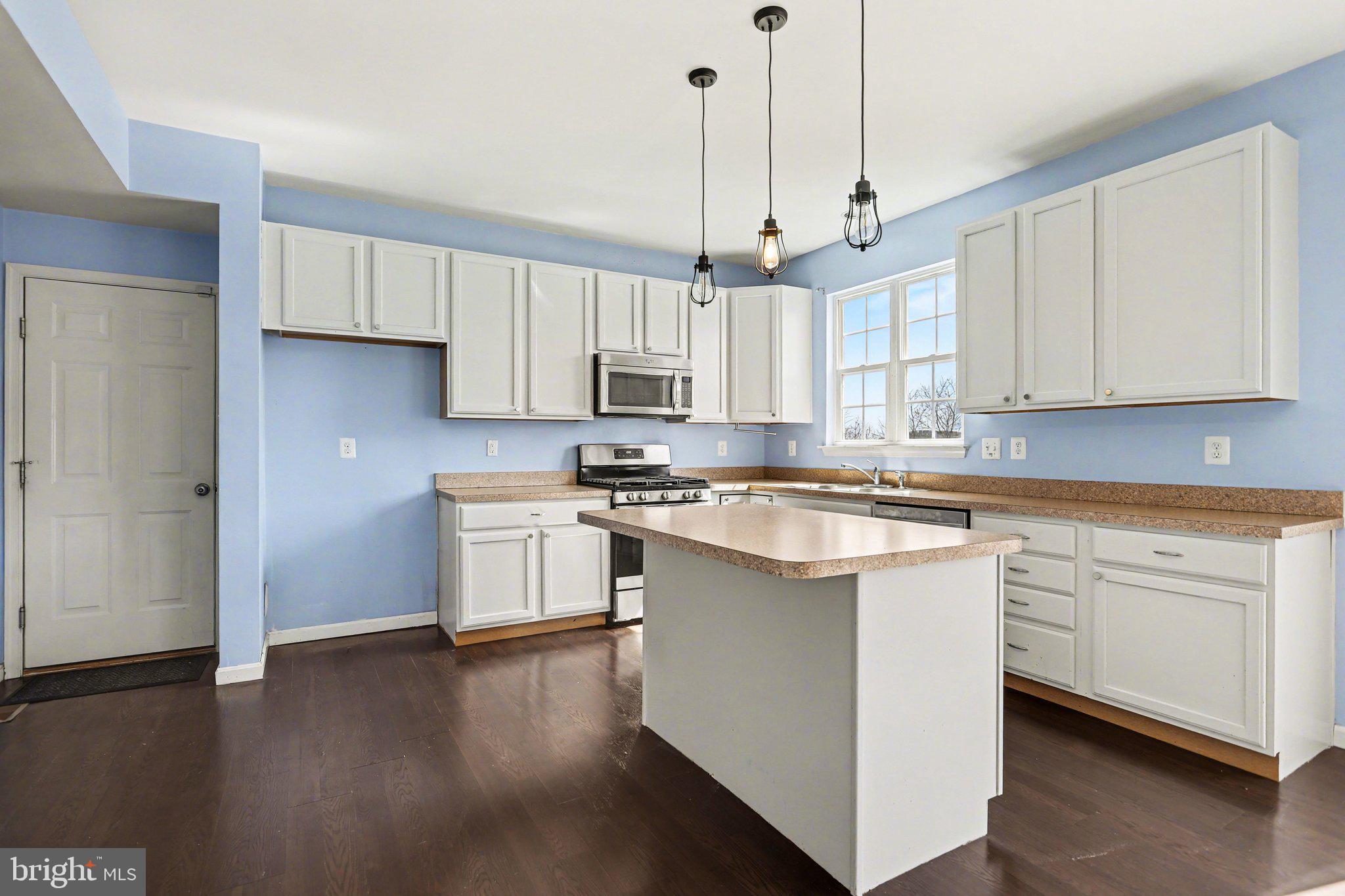 503 Windy Way New Cumberland, PA 17070 - Photo 4 of 29 a kitchen with stainless steel appliances granite countertop a sink a stove a refrigerator and island with wooden floor