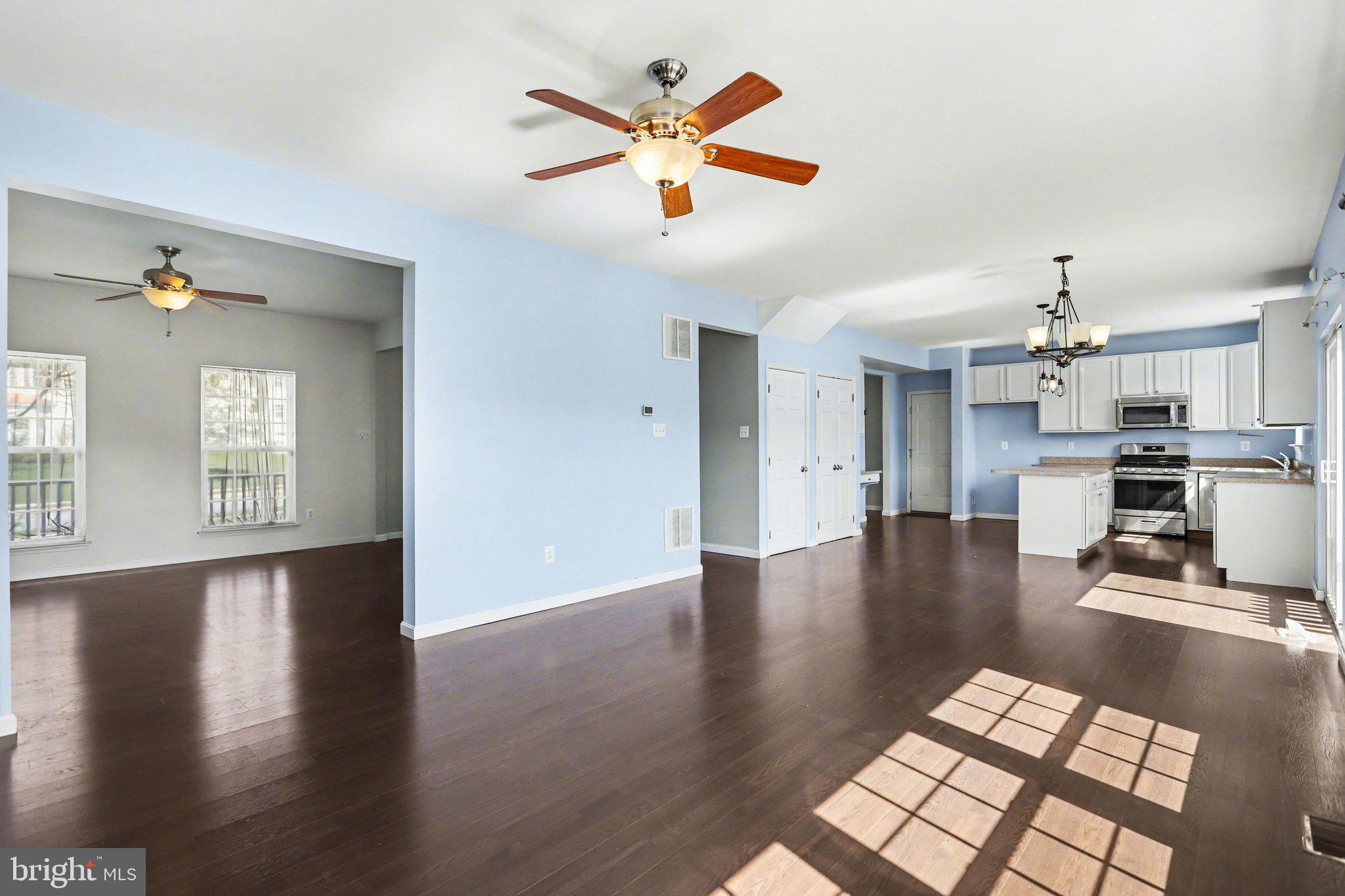 503 Windy Way New Cumberland, PA 17070 - Photo 6 of 29 a view of kitchen and hall with wooden floor and a ceiling fan