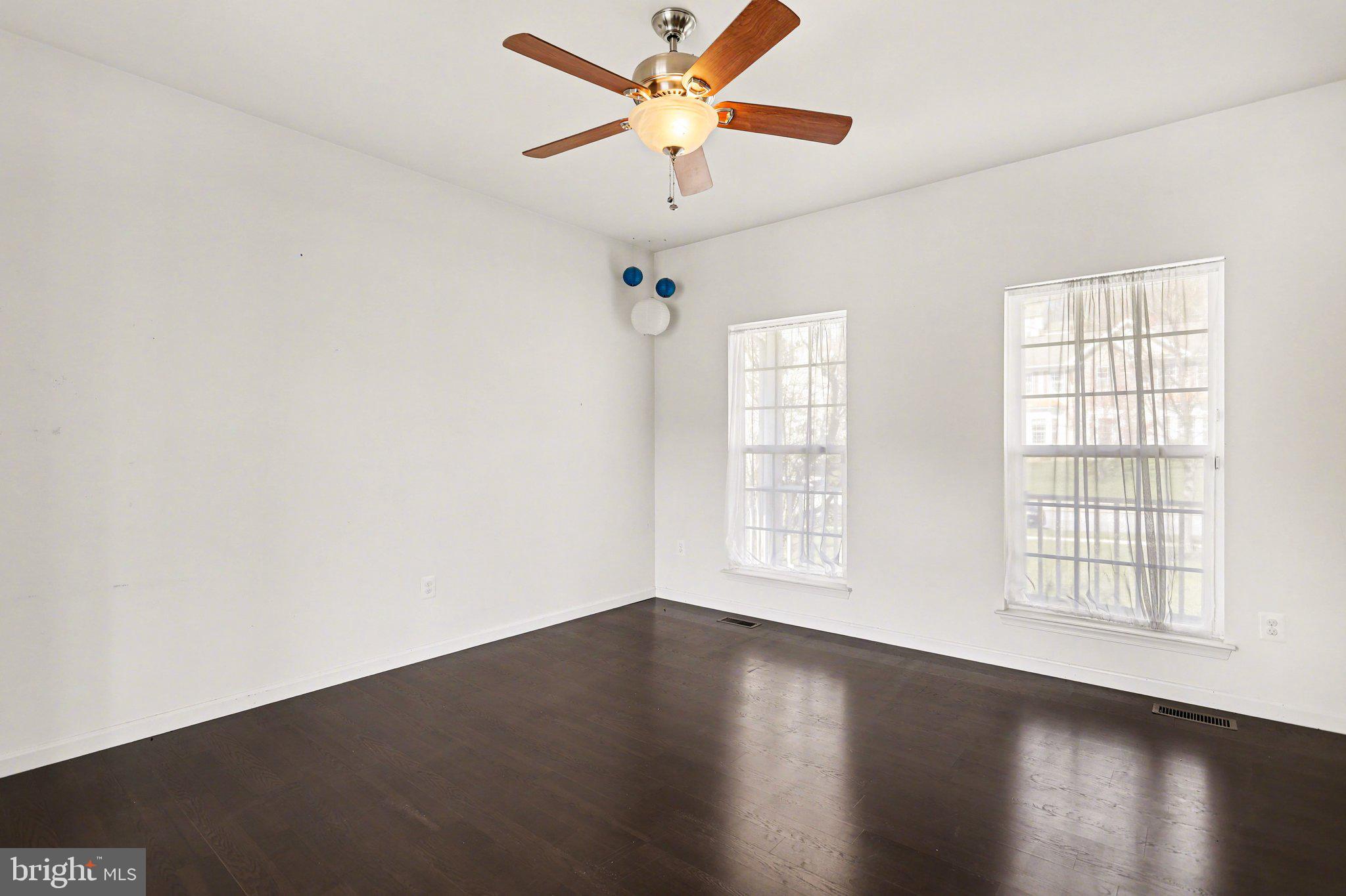 503 Windy Way New Cumberland, PA 17070 - Photo 7 of 29 an empty room with wooden floor chandelier fan and windows