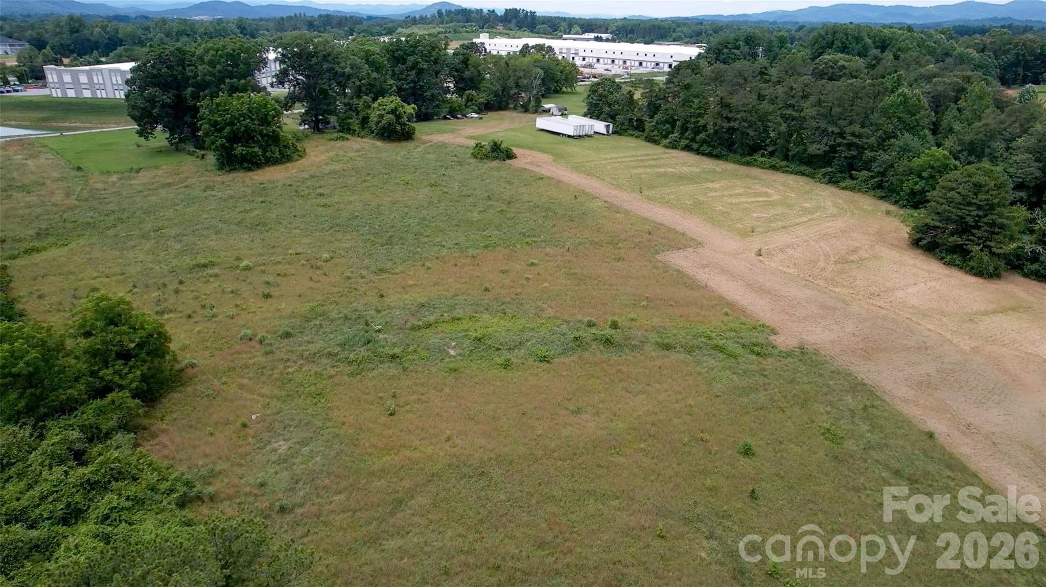 412 McMurray Road Flat Rock, NC 28731 - Photo 9 of 14 a view of a field with plants and trees
