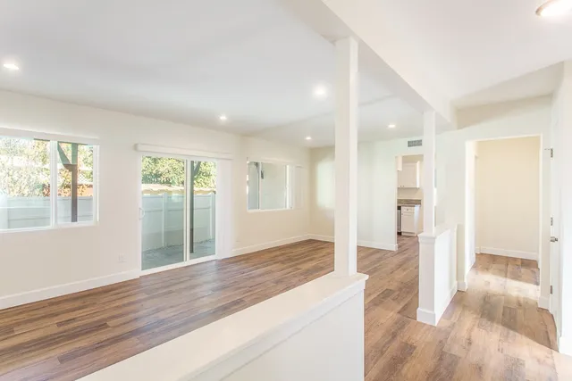 a view of wooden floor and windows in an empty room