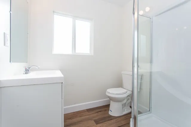 a bathroom with a sink toilet and a mirror