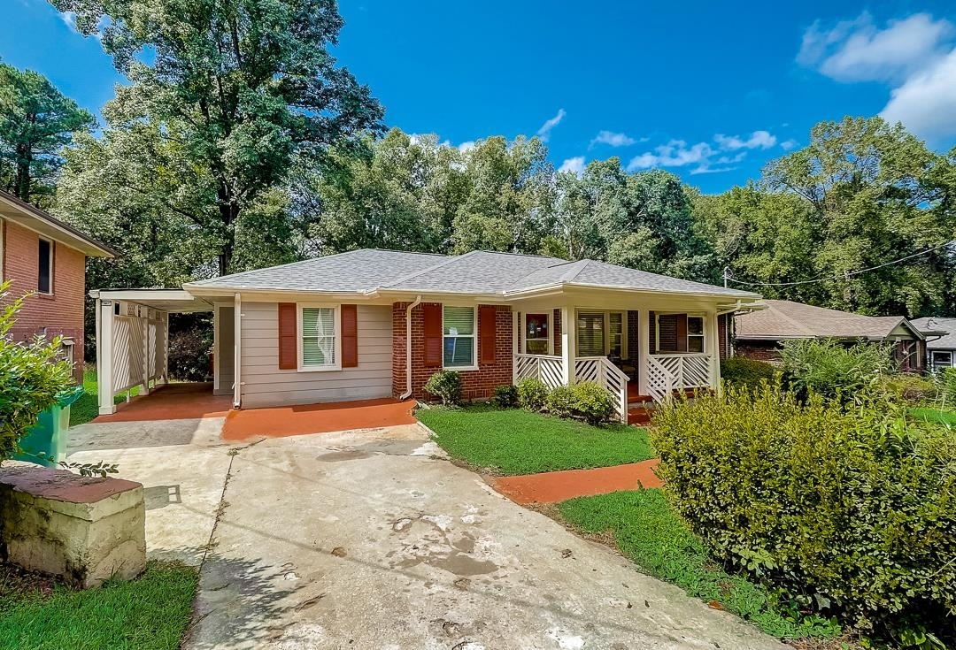 a front view of a house with a yard and porch