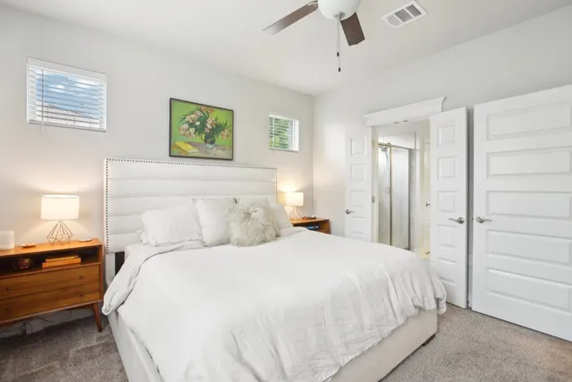 a bedroom with a bed and a night stand