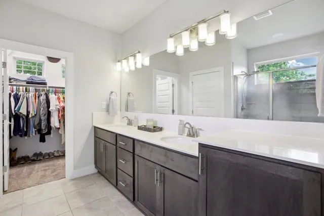 a bathroom with a sink vanity and a mirror