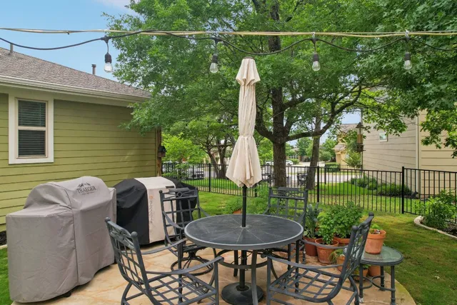 a view of a house with backyard sitting area and garden