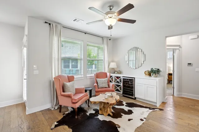 a living room with furniture a flat screen tv and a large window