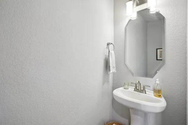 a bathroom with a sink and mirror