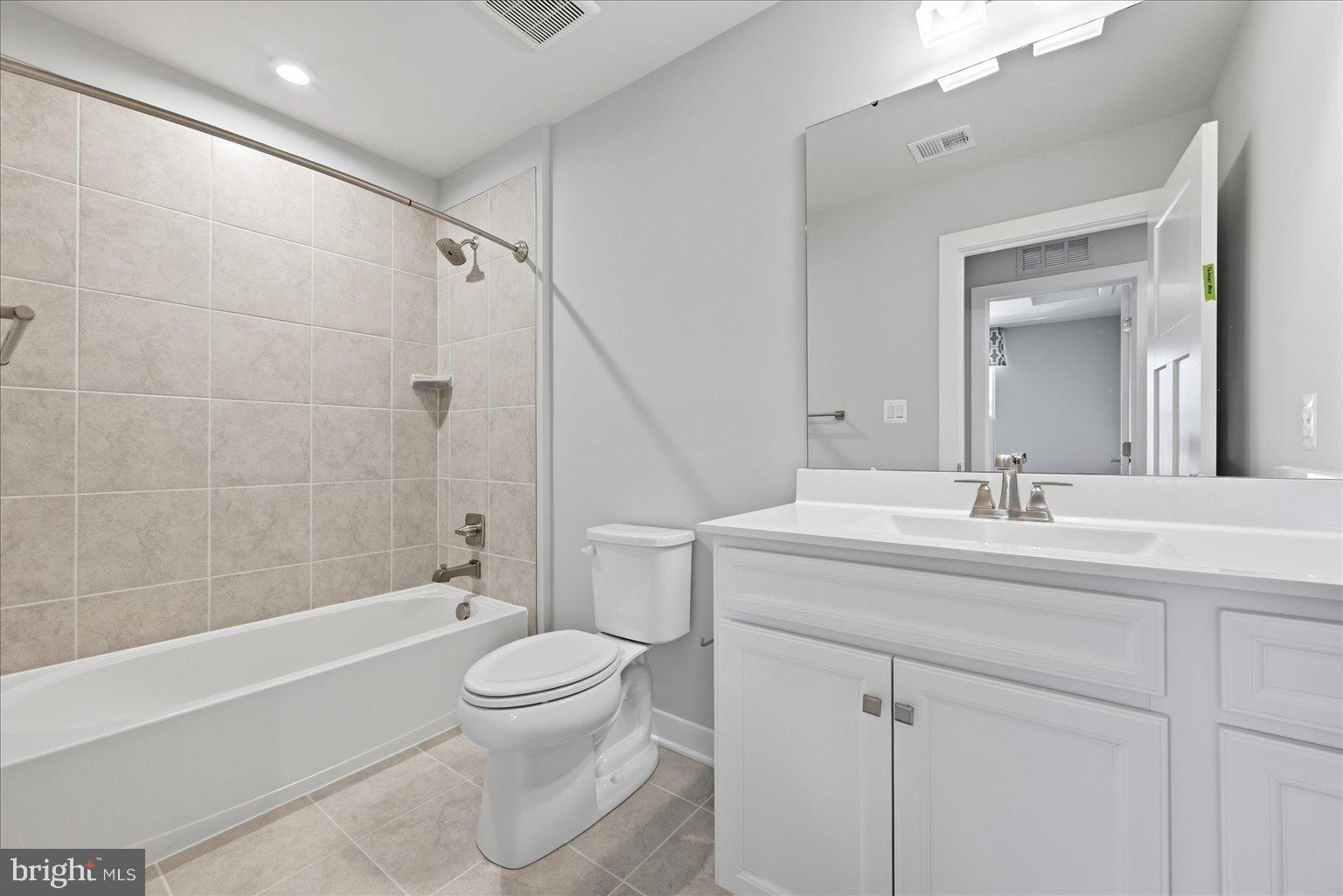14380 Longhouse Loop Brandywine, MD 20613 - Photo 11 of 20 a bathroom with a granite countertop sink a toilet and a bathtub