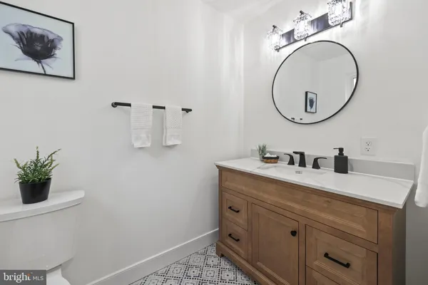 a kitchen with stainless steel appliances granite countertop a refrigerator a sink dishwasher a dining table and chairs with wooden floor