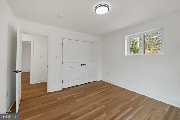 a view of a room with wooden floor and window