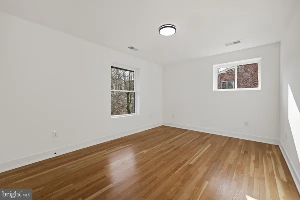 a view of an empty room and wooden floor