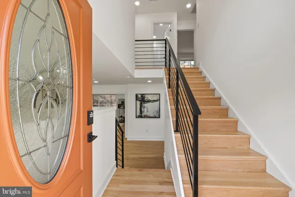 a view of a hallway with wooden floor and entryway