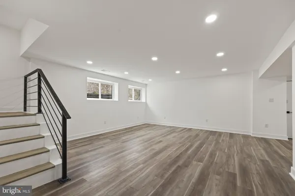 a view of a room with wooden floor and window