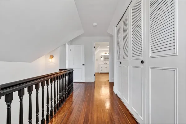 a view of a hallway with wooden floor