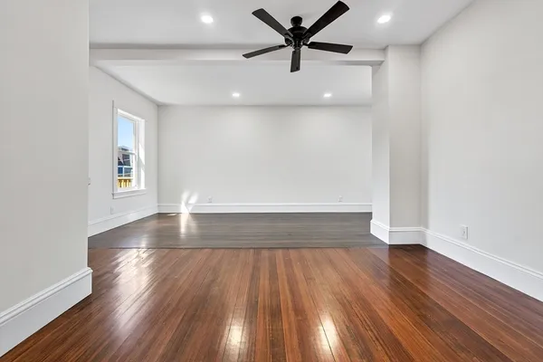 wooden floor in an empty room with a window