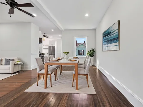 a view of a dining room with furniture and wooden floor