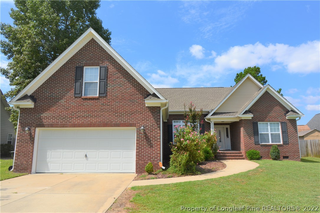 4308 Rocinta Court Hope Mills, NC 28348 - Photo 1 of 23 a front view of a house with a yard and garage