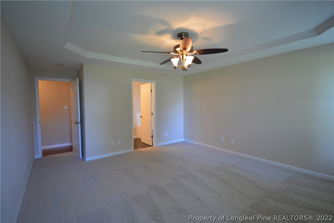 4308 Rocinta Court Hope Mills, NC 28348 - Photo 11 of 23 an empty room with a chandelier fan and windows