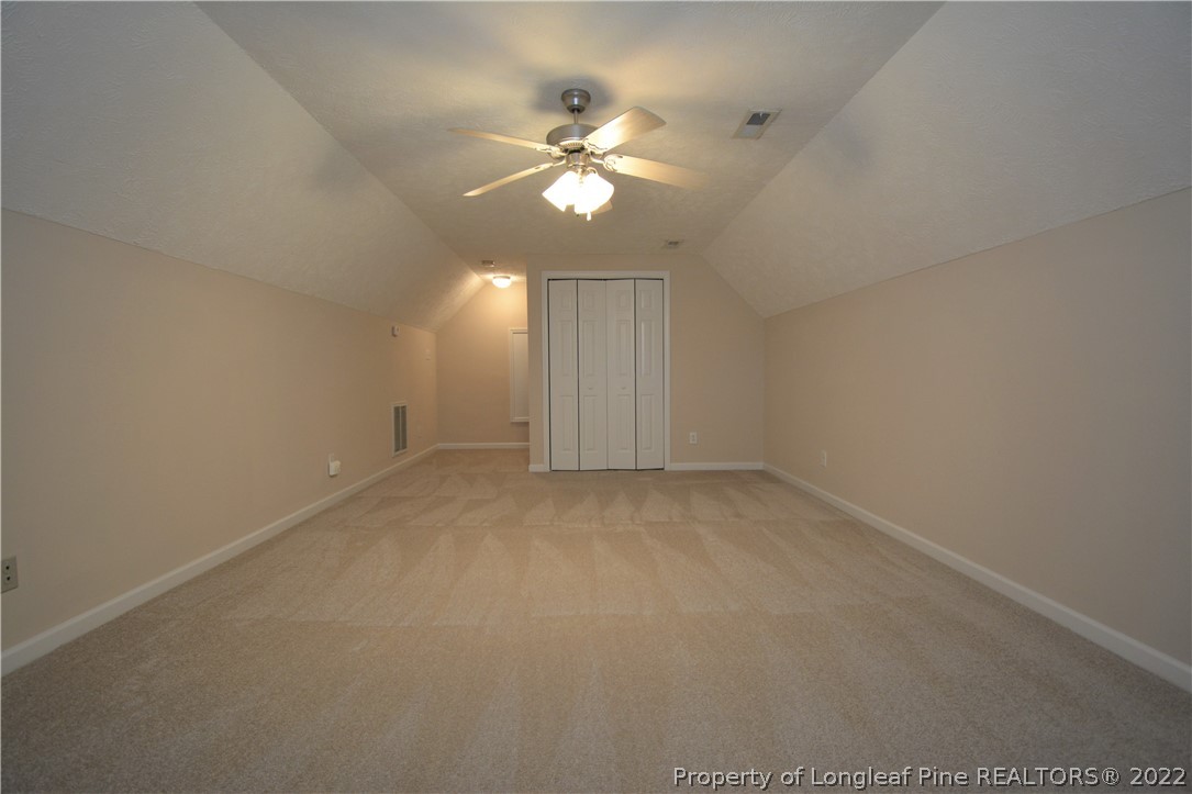 4308 Rocinta Court Hope Mills, NC 28348 - Photo 20 of 23 an empty room with a chandelier fan and windows