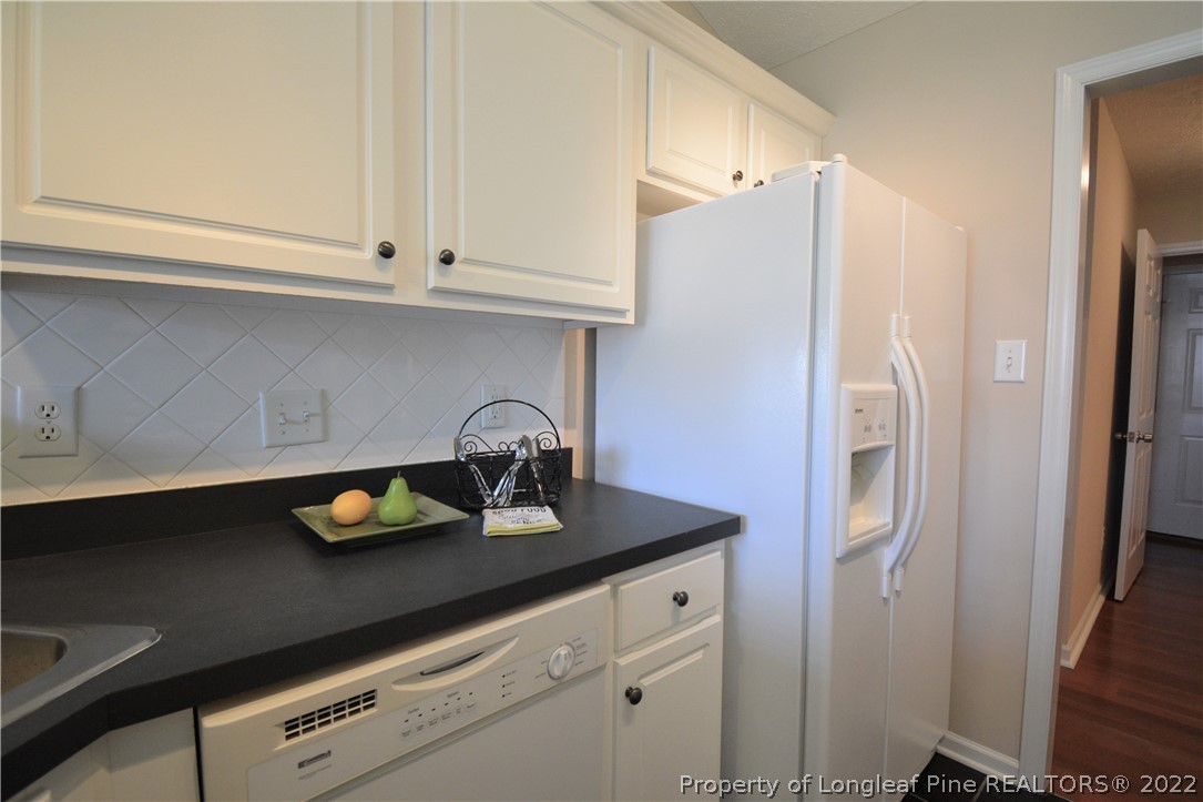 4308 Rocinta Court Hope Mills, NC 28348 - Photo 6 of 23 a kitchen with stainless steel appliances a sink a refrigerator and cabinets