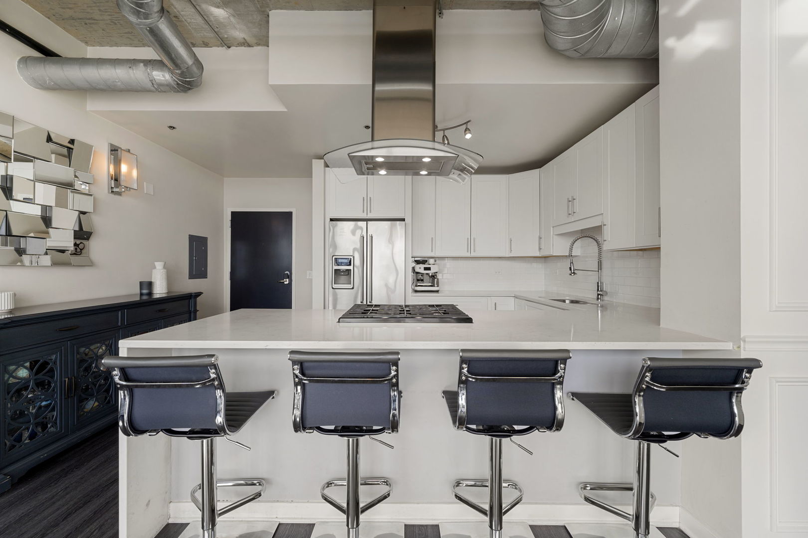 50 East 16th Street, Unit 1405 Chicago, IL 60616 - Photo 11 of 36 a kitchen with cabinets a counter and chairs