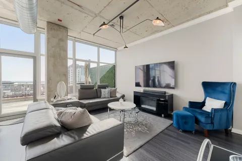 a living room with furniture and a fireplace