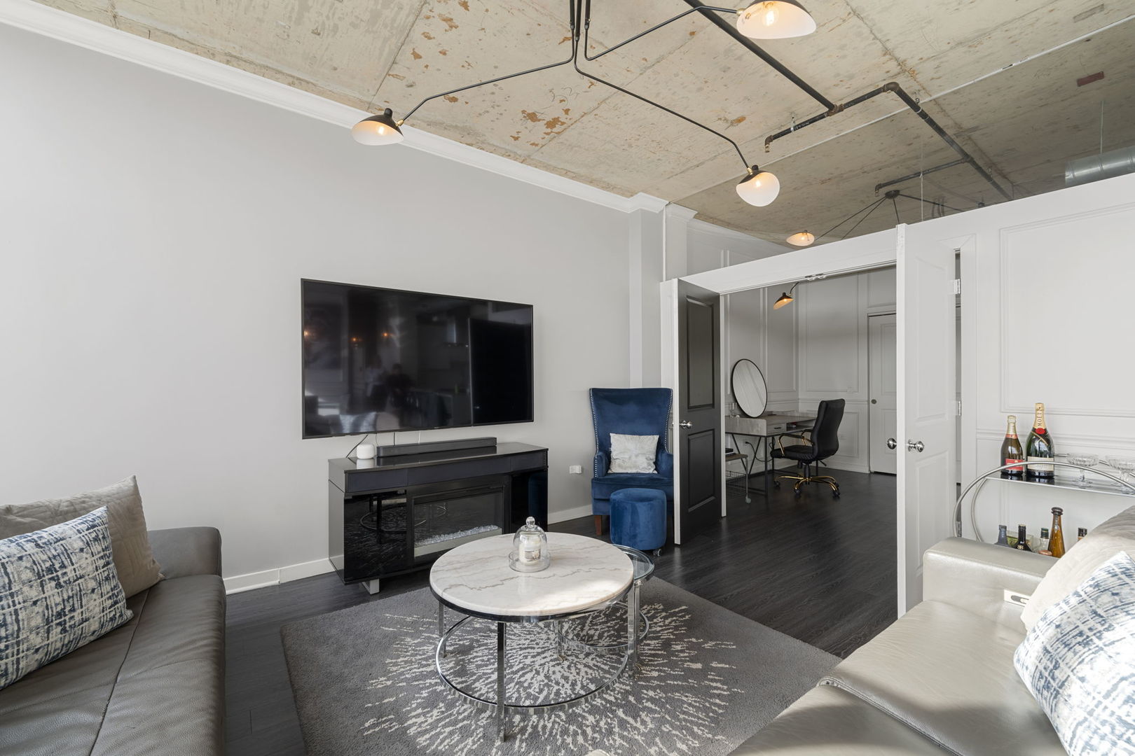 50 East 16th Street, Unit 1405 Chicago, IL 60616 - Photo 14 of 36 a living room with furniture and a flat screen tv