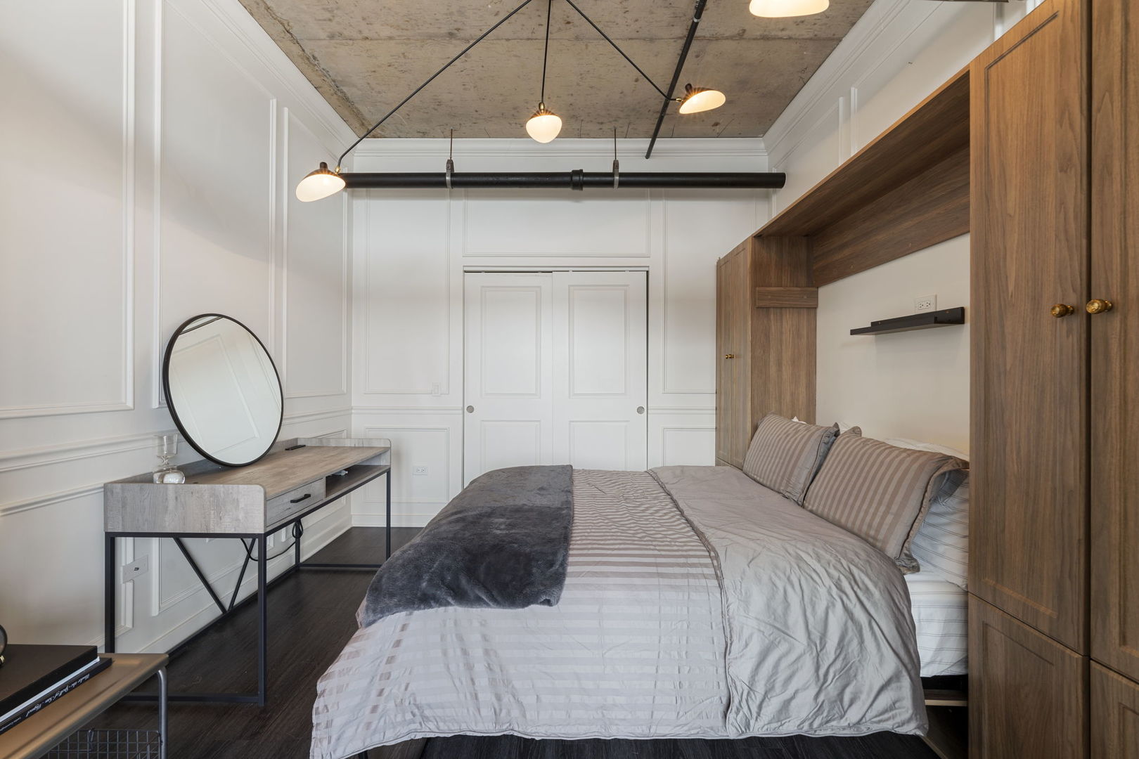 50 East 16th Street, Unit 1405 Chicago, IL 60616 - Photo 15 of 36 a bedroom with a bed a mirror with the wooden floor