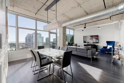 a dining room with furniture window and wooden floor