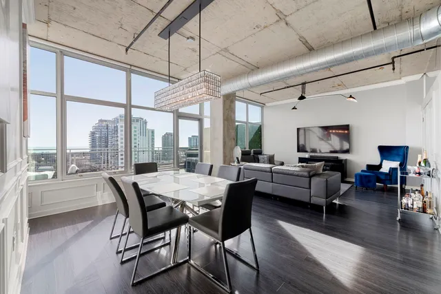 a dining room with furniture window and wooden floor