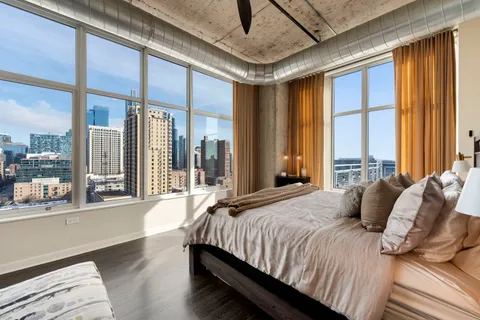 a bedroom with a large bed and a large window