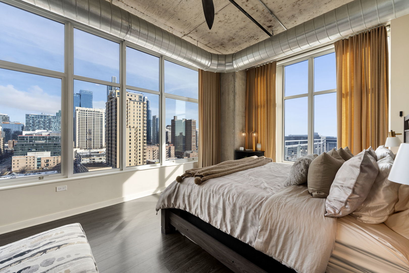50 East 16th Street, Unit 1405 Chicago, IL 60616 - Photo 21 of 36 a bedroom with a large bed and a large window