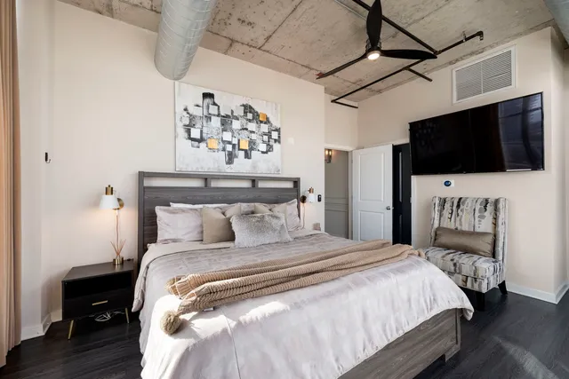 a bedroom with a bed and a flat screen tv