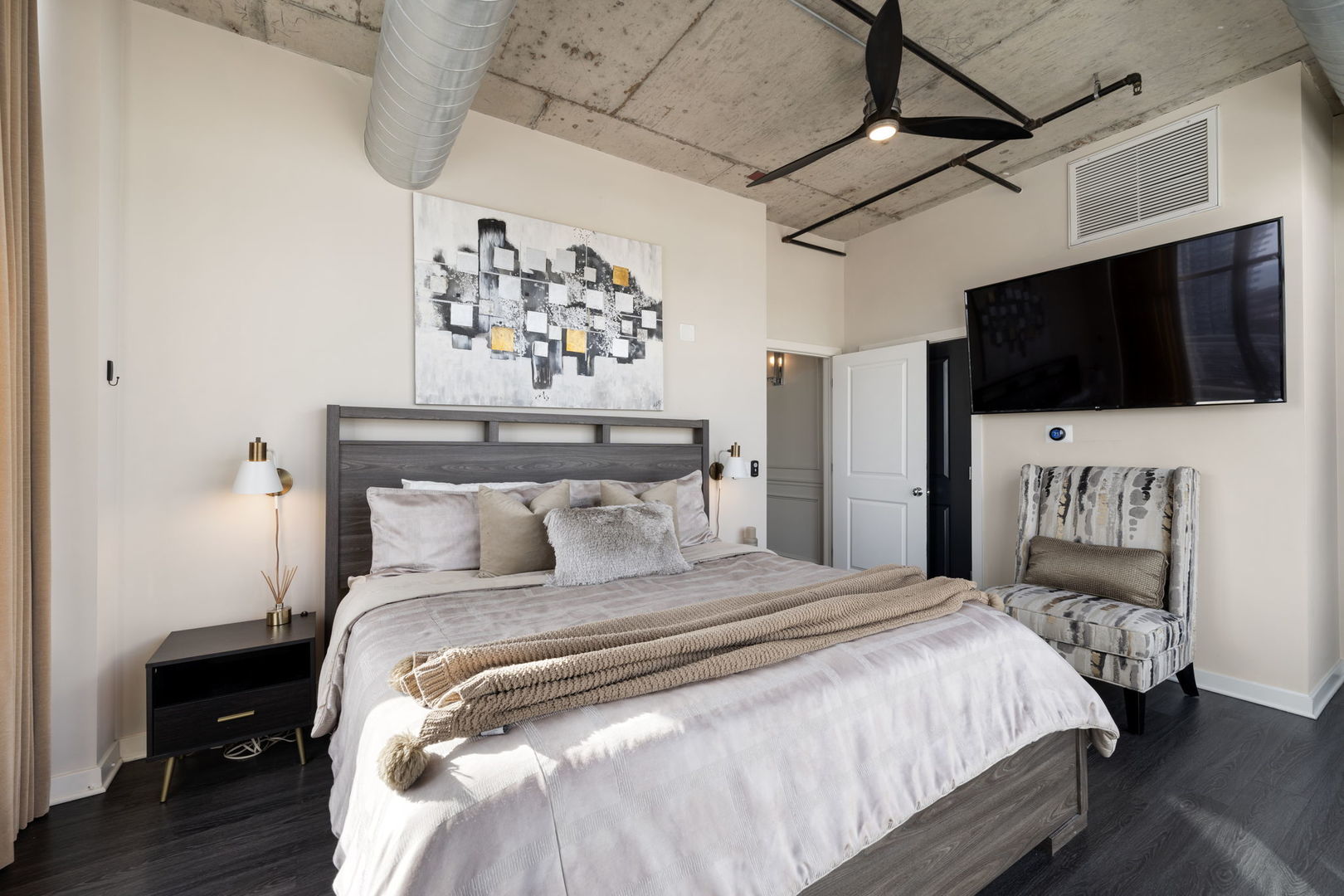 50 East 16th Street, Unit 1405 Chicago, IL 60616 - Photo 23 of 36 a bedroom with a bed and a flat screen tv