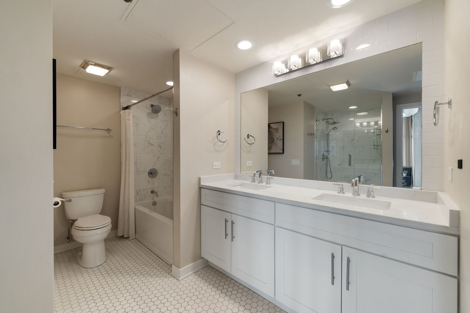 50 East 16th Street, Unit 1405 Chicago, IL 60616 - Photo 24 of 36 a spacious bathroom with a toilet sink double and mirror